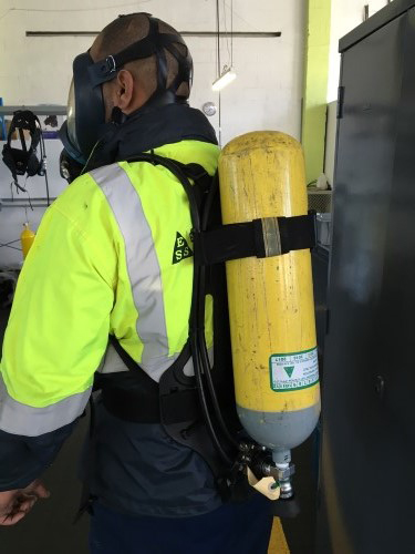Technician wearing a self contained breathing apparatus set